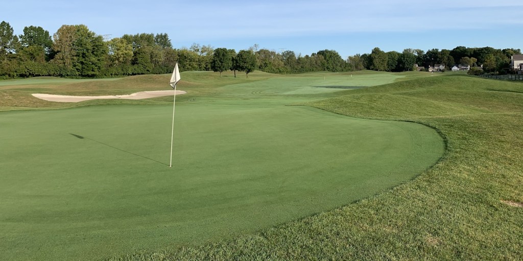 Flag on golf course near bunker